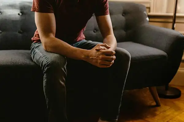 a man with depression sitting on a couch