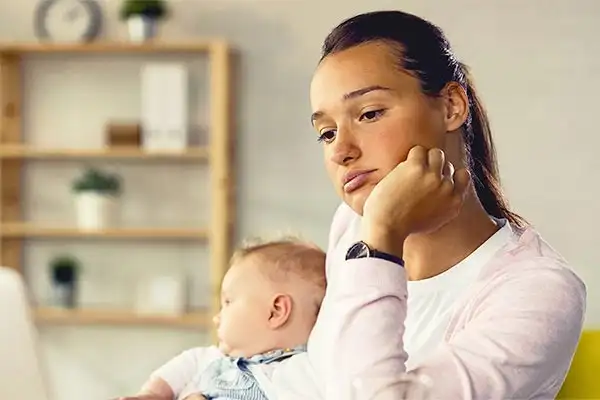 a mother with Postpartum Depression holding a child